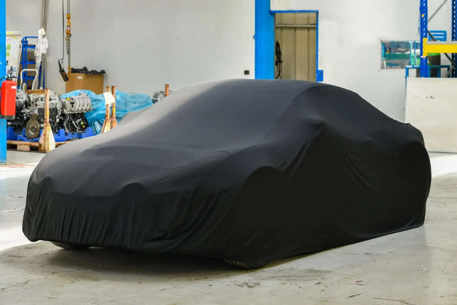 Car with a dust cover over it.
